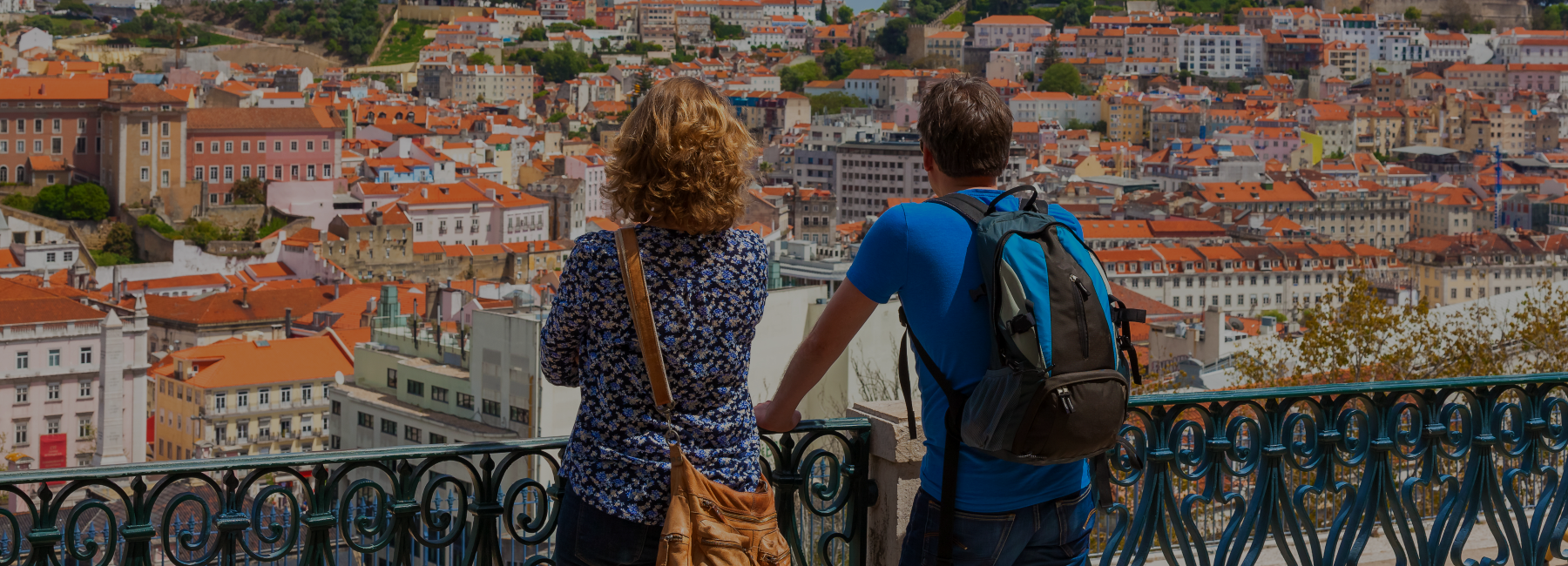 two tourists enjoying the incredible view of rooftop in lisbon