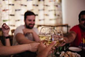 People cheering with green wine to be tasted during the best food tour in Lisbon with treasures of lisboa food tours